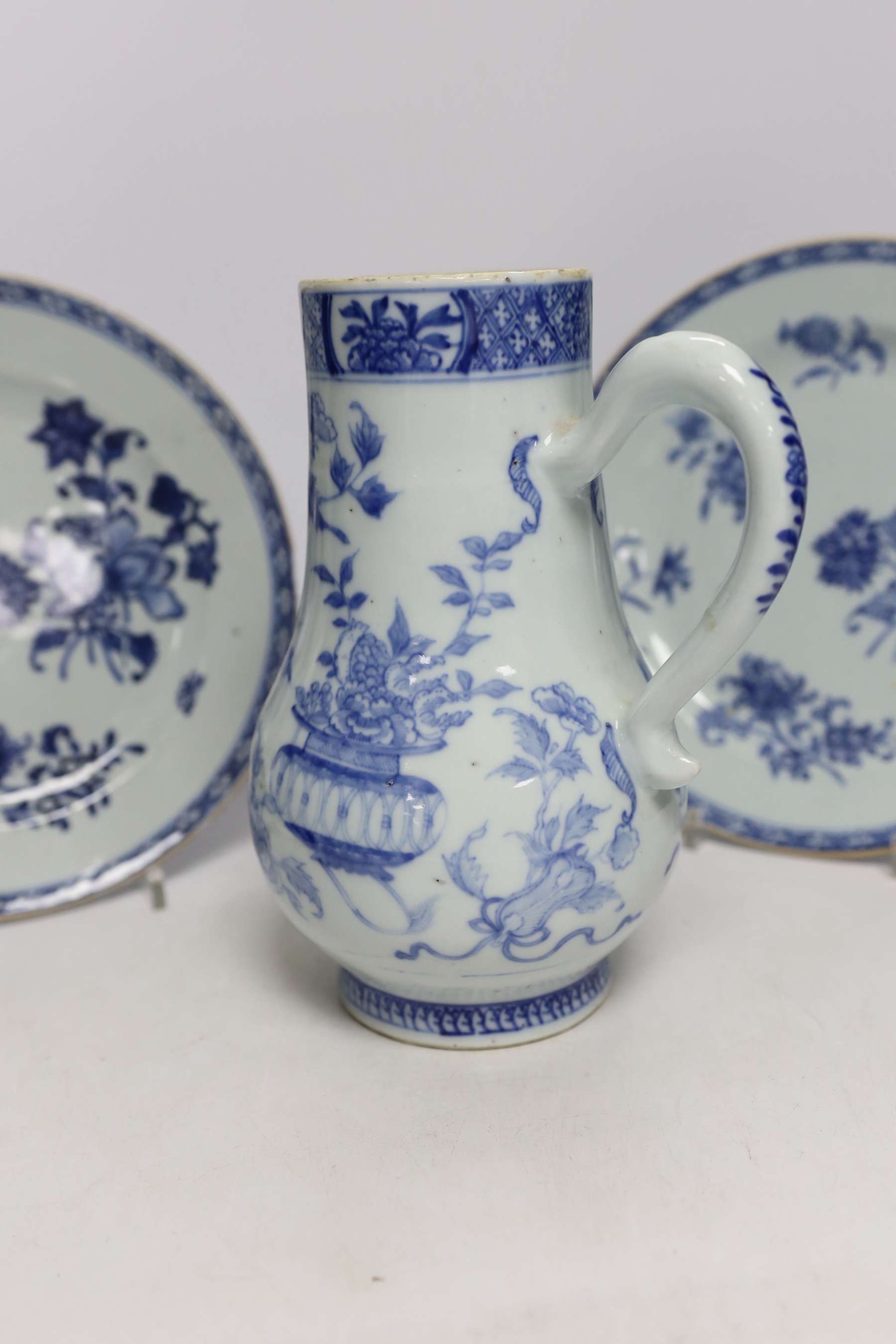 A Chinese 18th century reticulated double walled tea bowl and saucer, two blue and white plates and a jug (5)